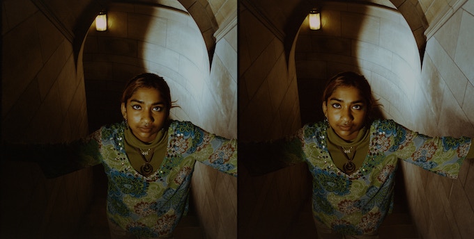 Woman in stairwell looking above camera